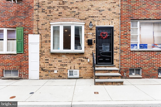 property entrance with brick siding