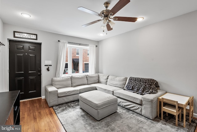 living room with a ceiling fan and wood finished floors