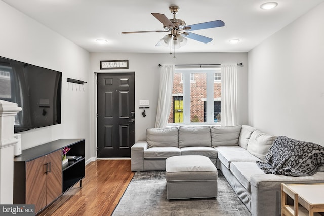 living room featuring wood finished floors and a ceiling fan