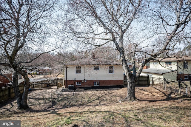 back of house featuring a fenced backyard