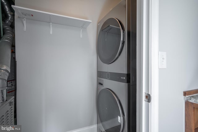 laundry area featuring stacked washer and dryer and laundry area