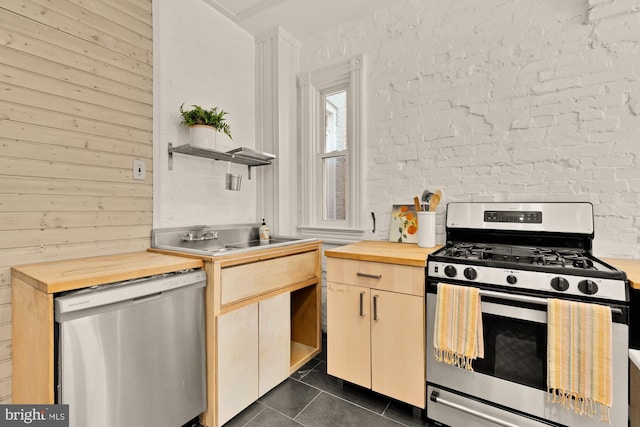 121 Kentucky Ave SE, Washington, DC 20003 - kitchen with appliances with stainless steel finishes, butcher block counters, open shelves, and dark tile patterned flooring
