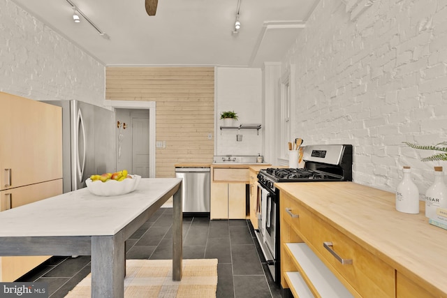 121 Kentucky Ave SE, Washington, DC 20003 - kitchen featuring stainless steel appliances, rail lighting, open shelves, dark tile patterned flooring, and wooden counters