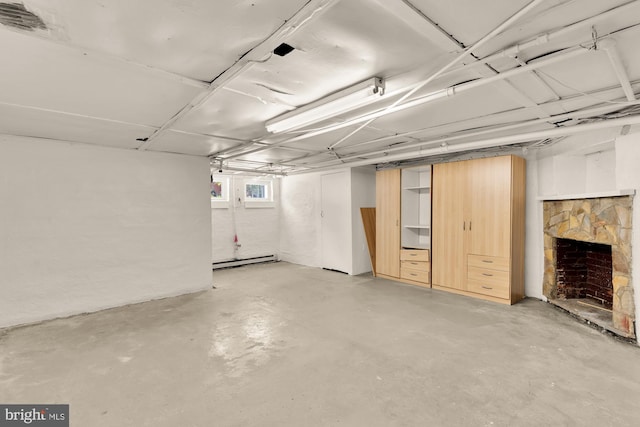 121 Kentucky Ave SE, Washington, DC 20003 - below grade area featuring a baseboard heating unit and a fireplace