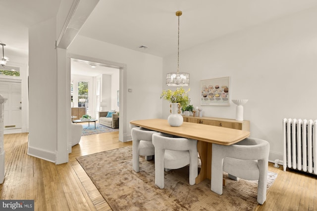 121 Kentucky Ave SE, Washington, DC 20003 - dining area featuring radiator heating unit, a chandelier, and light wood-type flooring