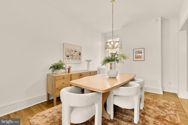 121 Kentucky Ave SE, Washington, DC 20003 - dining area with a chandelier, light wood-type flooring, and radiator heating unit