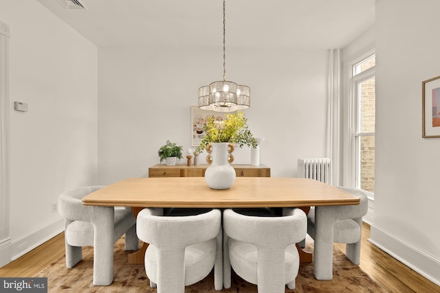 121 Kentucky Ave SE, Washington, DC 20003 - dining room featuring a chandelier, wood finished floors, and radiator heating unit