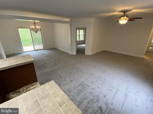 unfurnished living room with carpet floors, ornamental molding, baseboards, and ceiling fan with notable chandelier