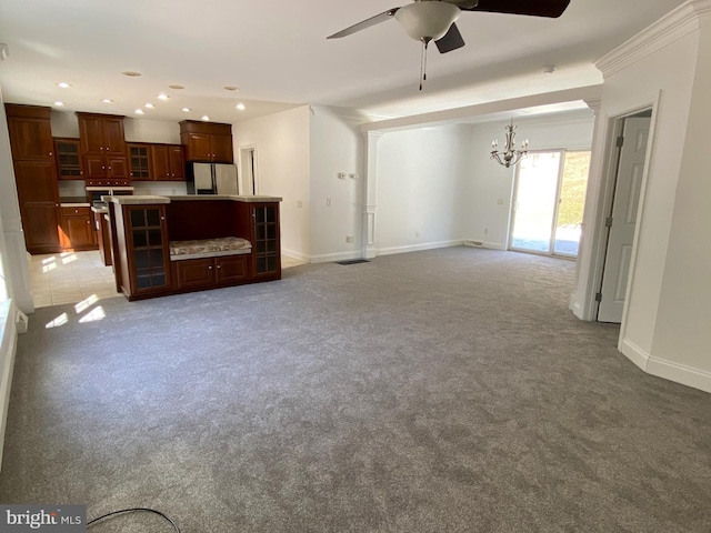 unfurnished living room featuring light carpet, baseboards, and recessed lighting