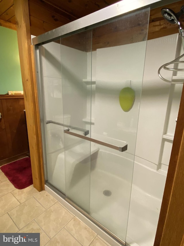 full bath featuring a shower stall and tile patterned floors