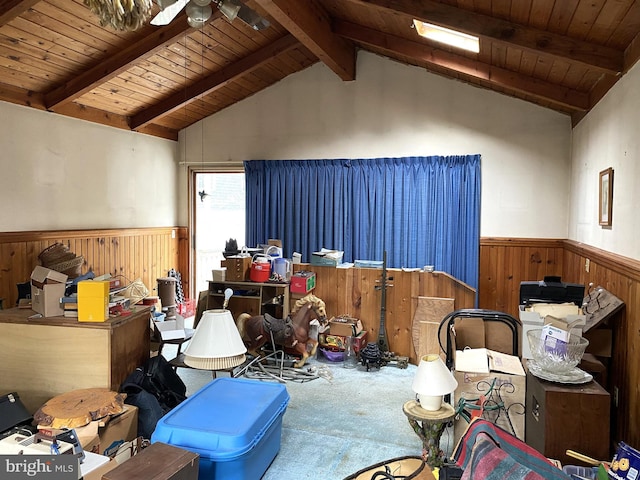 misc room featuring carpet floors, wooden ceiling, wainscoting, and lofted ceiling with beams