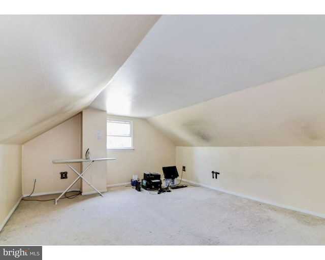 bonus room featuring lofted ceiling, carpet, and baseboards