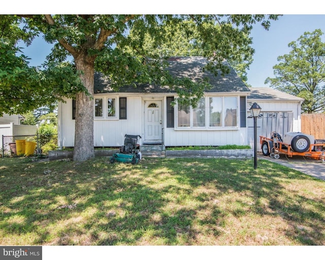 view of front facade featuring fence, a front lawn, and board and batten siding