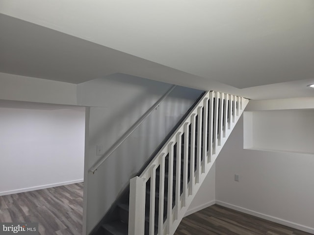 stairway featuring wood finished floors and baseboards