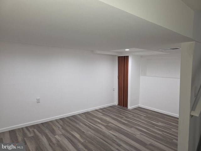finished basement featuring recessed lighting, dark wood finished floors, and baseboards