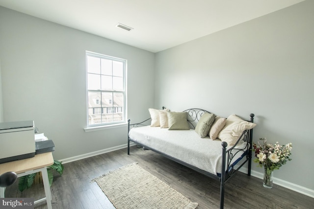 sitting room featuring visible vents, baseboards, and wood finished floors