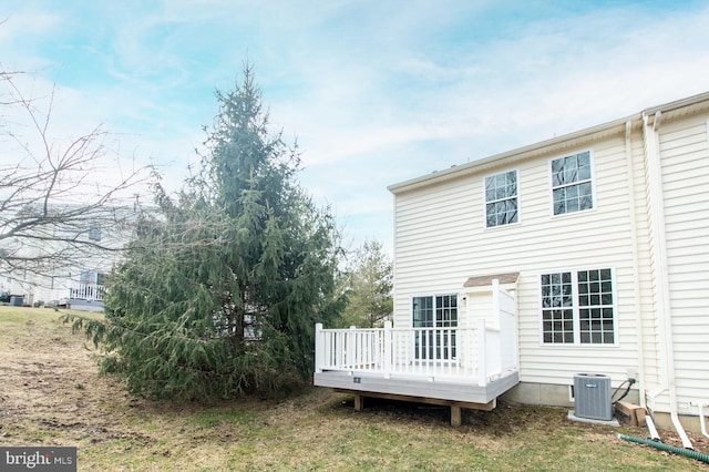 back of house featuring a wooden deck and central AC unit