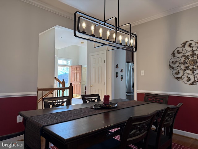 dining space with baseboards and ornamental molding