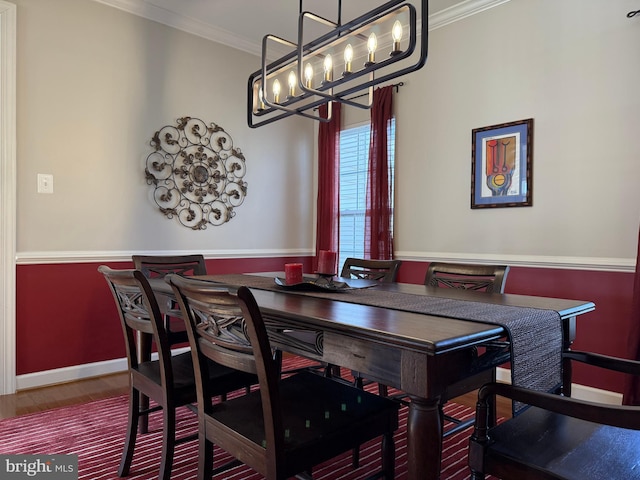 dining room featuring baseboards, crown molding, and wood finished floors