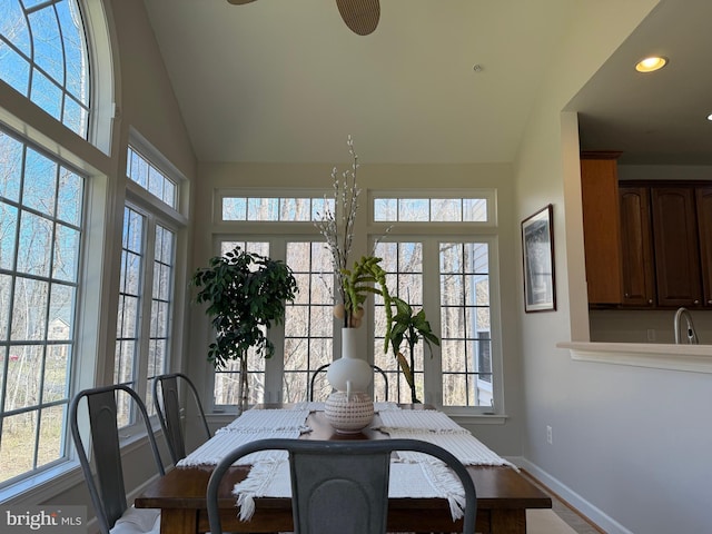 dining area with recessed lighting, vaulted ceiling, and baseboards