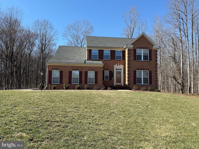 colonial-style house with a front lawn and brick siding