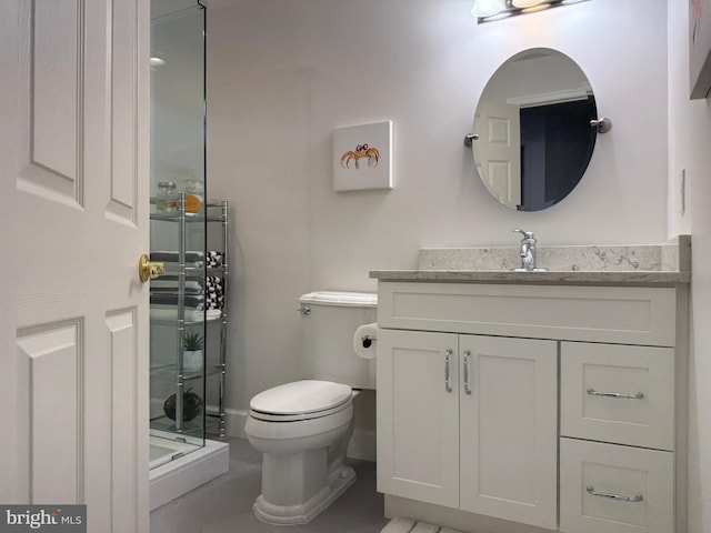 bathroom with toilet, a stall shower, and vanity