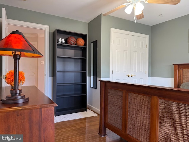 interior space featuring dark wood-style floors, ceiling fan, and a closet