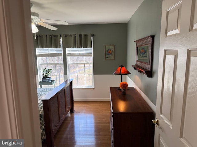 interior space with wood finished floors and baseboards