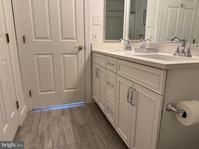 full bath with a sink and double vanity