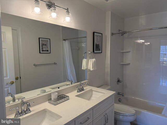 bathroom featuring a sink, toilet, and shower / bath combo with shower curtain