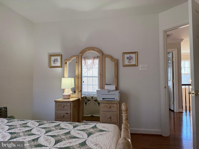 bedroom with baseboards and wood finished floors