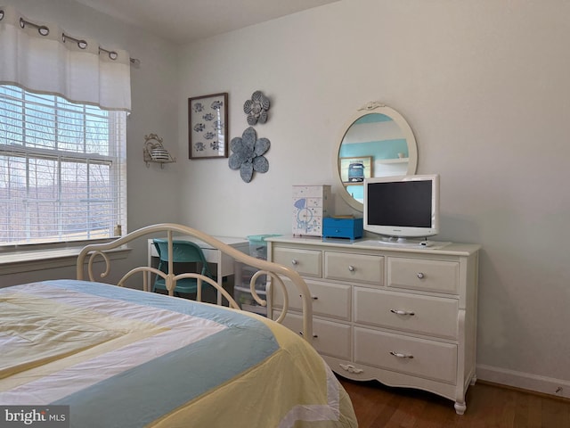 bedroom featuring dark wood-type flooring and baseboards