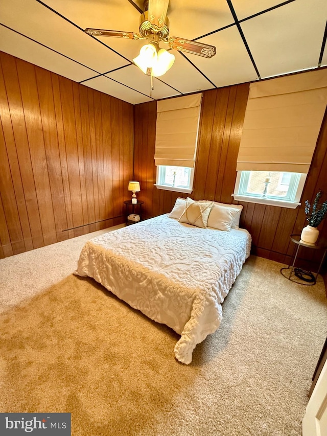 unfurnished bedroom featuring carpet floors and wooden walls