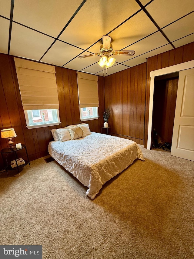 unfurnished bedroom with wood walls, carpet, and visible vents