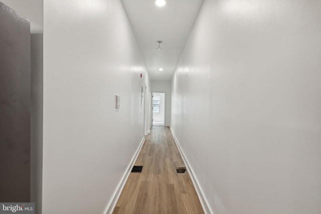 corridor with recessed lighting, light wood-type flooring, visible vents, and baseboards