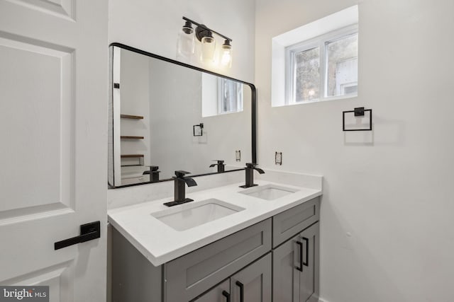 bathroom featuring a sink and double vanity