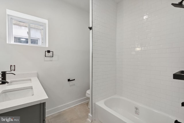 bathroom with baseboards, toilet, shower / tub combination, tile patterned floors, and a sink