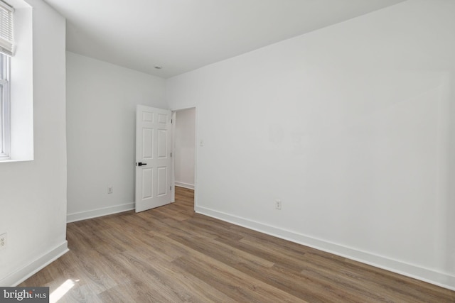 spare room with light wood-type flooring and baseboards