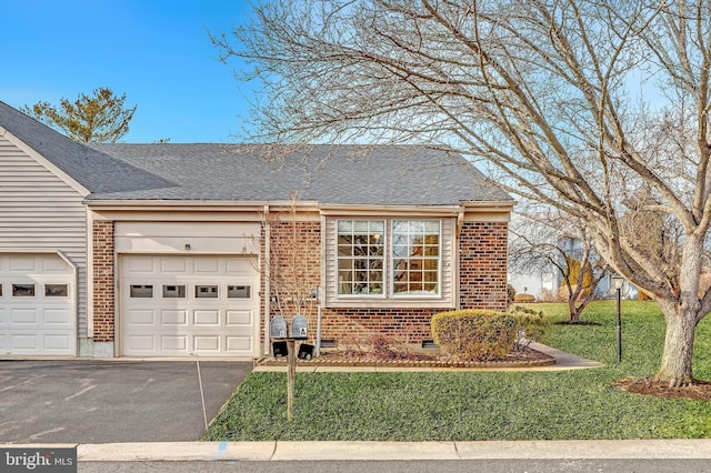 view of front of property with a garage, driveway, a front yard, and brick siding