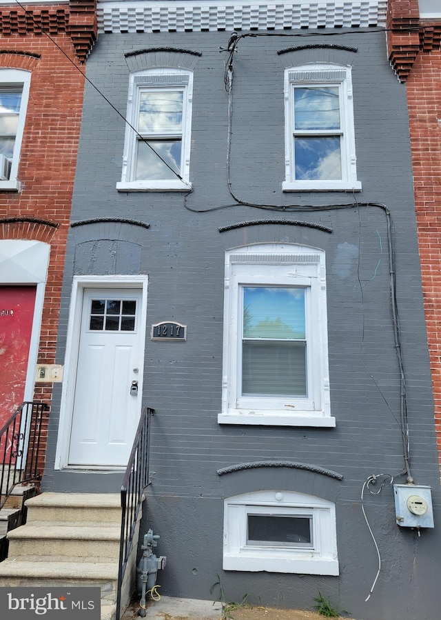 view of property featuring brick siding