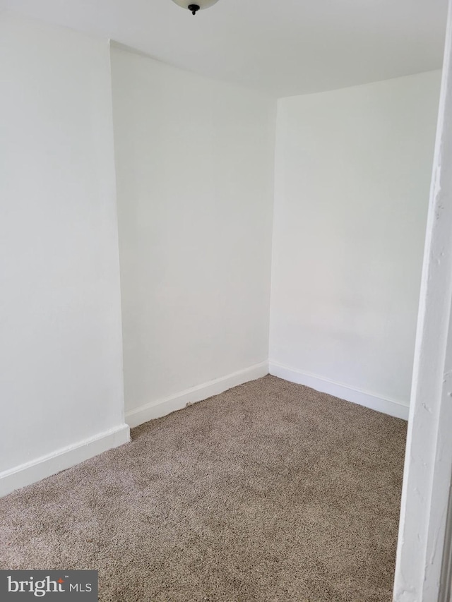 empty room featuring carpet flooring and baseboards