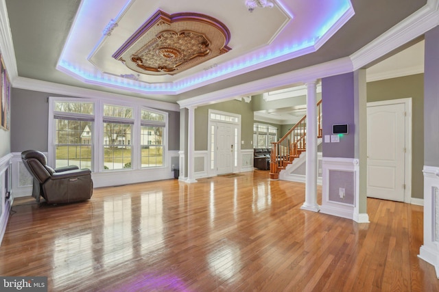 2205 Dhow Ct, Bowie, MD 20721 - entryway with a raised ceiling, ornate columns, a decorative wall, ornamental molding, and wood finished floors