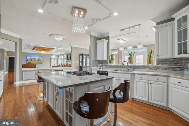 2205 Dhow Ct, Bowie, MD 20721 - kitchen with crown molding, tasteful backsplash, a kitchen island, glass insert cabinets, and a kitchen breakfast bar