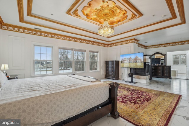 2205 Dhow Ct, Bowie, MD 20721 - bedroom featuring a tray ceiling, a chandelier, multiple windows, ornamental molding, and a decorative wall