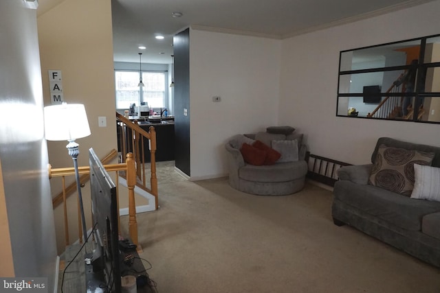 carpeted living room with ornamental molding and baseboards