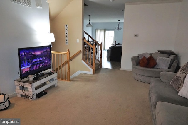 carpeted living room featuring stairs, visible vents, and baseboards