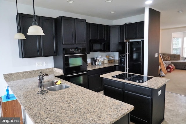 kitchen featuring dark cabinets, a sink, a peninsula, and black appliances