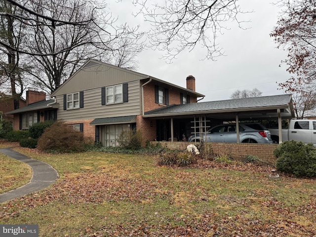 view of front of property featuring a carport, brick siding, a front yard, and a chimney