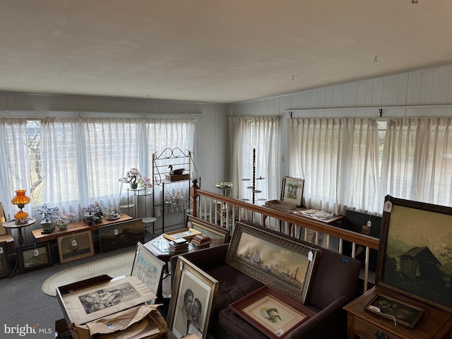 carpeted living room featuring lofted ceiling