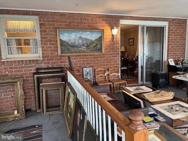 interior space with brick wall and a wood stove